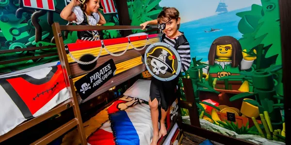 Two kids play pirates in their Pirate Island Hotel bunk beds.